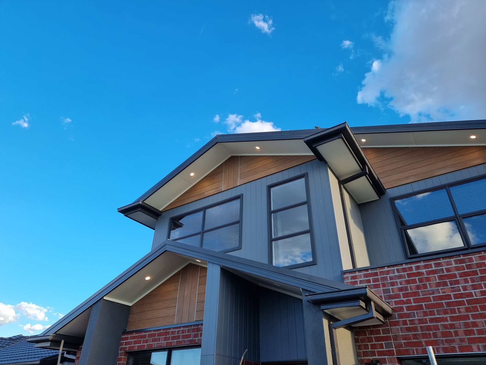 Modern two-storey home with lit eave downlights